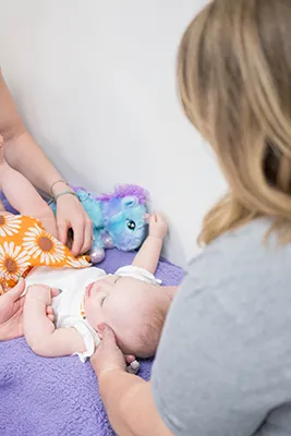 Chiropractor Hampton IL Laura Stone Adjusting An Infant